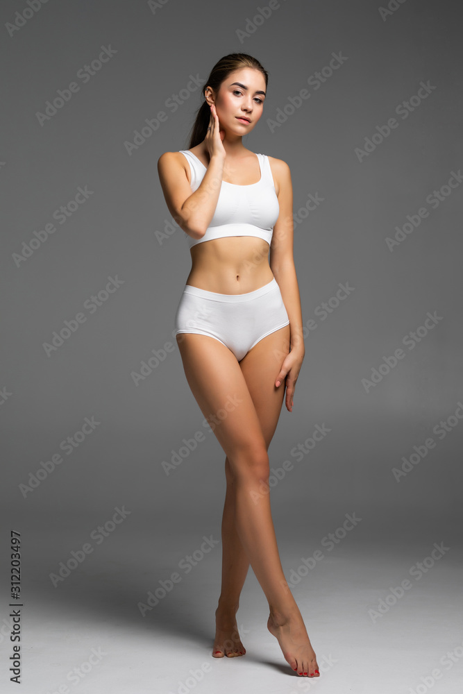 Beautiful slim woman in white lingerie. Beautiful female body isolated on  white. Beautiful Woman. Perfect Body. Full length portrait of happy young  woman in lingerie. Diet, healthy lifestyle. Stock-bilde