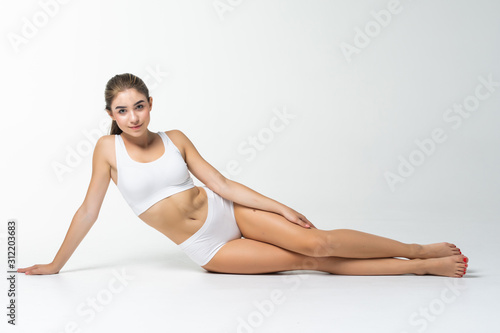 Young woman with a beautiful long legs isolated on white background