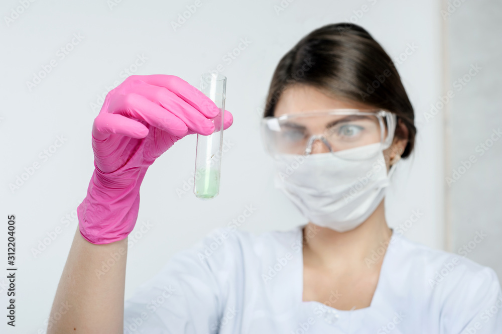 research conducted by a laboratory assistant holding a test tube of the agro-laboratory research conducted by a laboratory assistant holding a test tube of the agro-laboratory