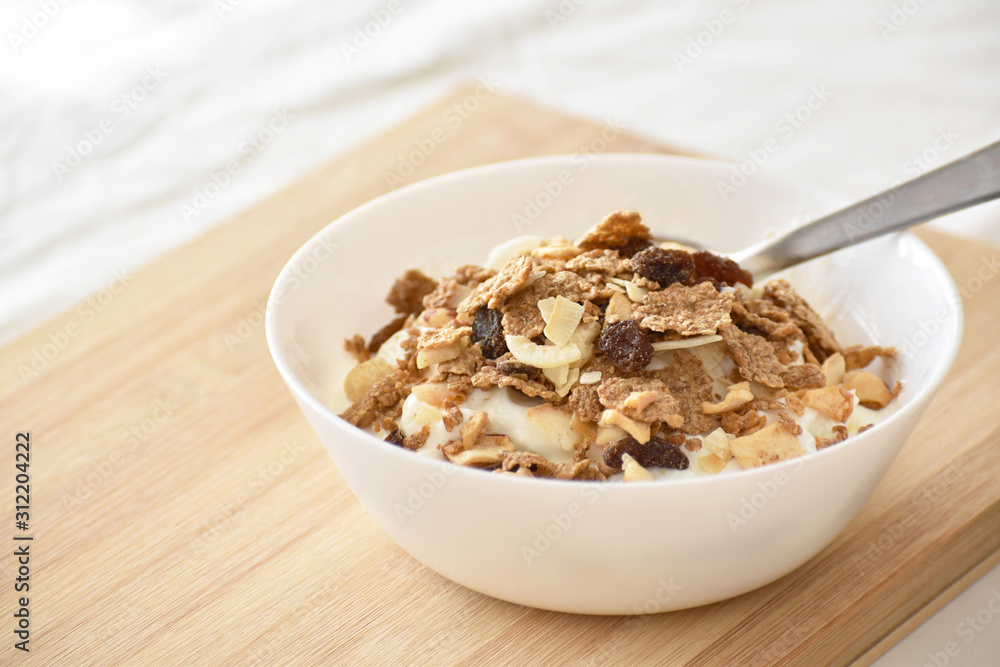 Greek yogurt with fruit and fiber cereal on a bowl. The concept of healthy breakfast, healthy food, dietary plan and weight loss program. Greek yogurt with fruit and fiber cereal on a bowl. The concept of healthy breakfast, healthy food, dietary plan and weight loss program.