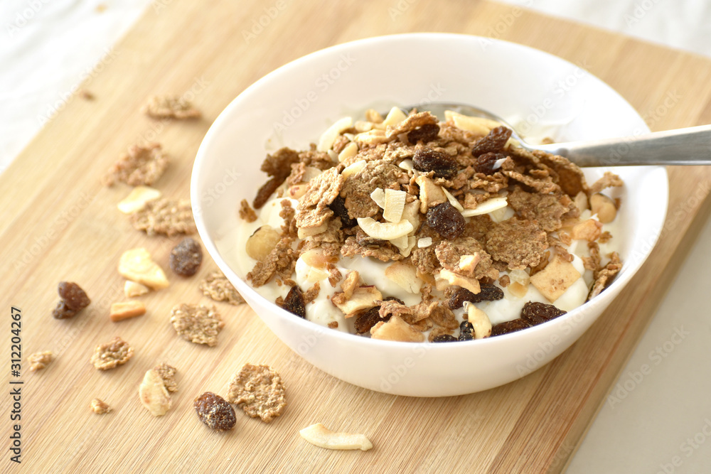 Greek yogurt with fruit and fiber cereal on a bowl. The concept of healthy breakfast, healthy food, dietary plan and weight loss program. Greek yogurt with fruit and fiber cereal on a bowl. The concept of healthy breakfast, healthy food, dietary plan and weight loss program.