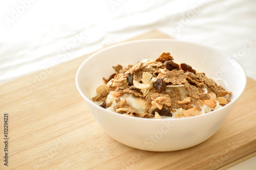 Greek yogurt with fruit and fiber cereal on a bowl. The concept of healthy breakfast, healthy food, dietary plan and weight loss program.