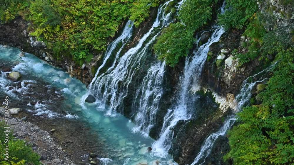 Aerial view of beautiful Shirahige Waterfalls tumbling down into Biei River in Biei, Hokkaido, Japan Aerial view of beautiful Shirahige Waterfalls tumbling down into Biei River in Biei, Hokkaido, Japan