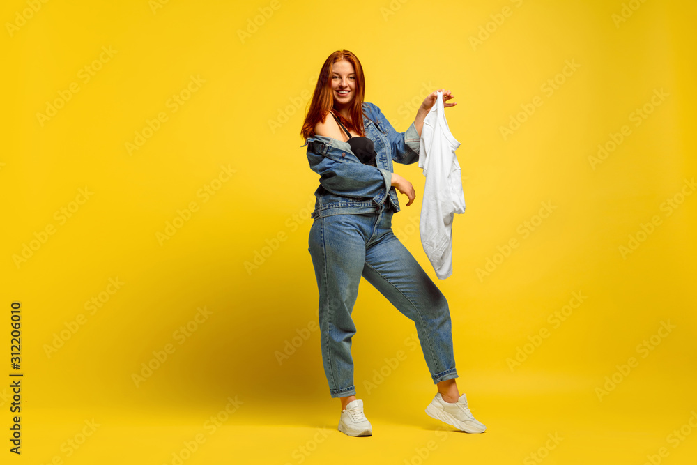 It's easier to be follower. Laundry faster, if it's only one shirt. Caucasian woman's portrait on yellow background. Beautiful red hair model. Concept of human emotions, facial expression, sales, ad. It's easier to be follower. Laundry faster, if it's only one shirt. Caucasian woman's portrait on yellow background. Beautiful red hair model. Concept of human emotions, facial expression, sales, ad.