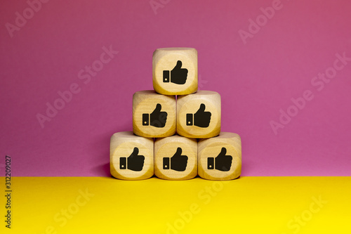 Pictogrammes de like / pouces en l'air sur cubes en bois photo