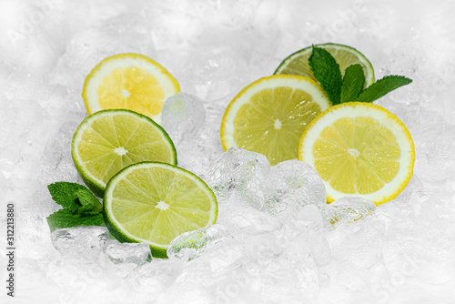 Lemon, Green Lemon and mint with crushed ice / ices cubes. Lemon ring. Ice background. Healty 2020.