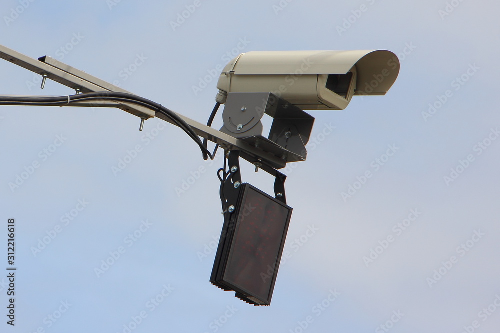 Highway speedcam control speed limit unit close up side view on a mast in Moscow on blue sky background Highway speedcam control speed limit unit close up side view on a mast in Moscow on blue sky background