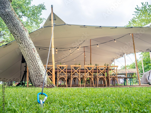 Image of huge white tent for a wedding event in the nature