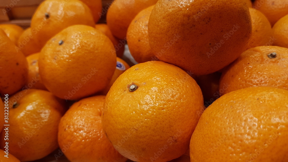 Oranges on display shelf at a market Oranges on display shelf at a market