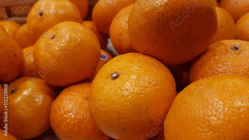 Oranges on display shelf at a market