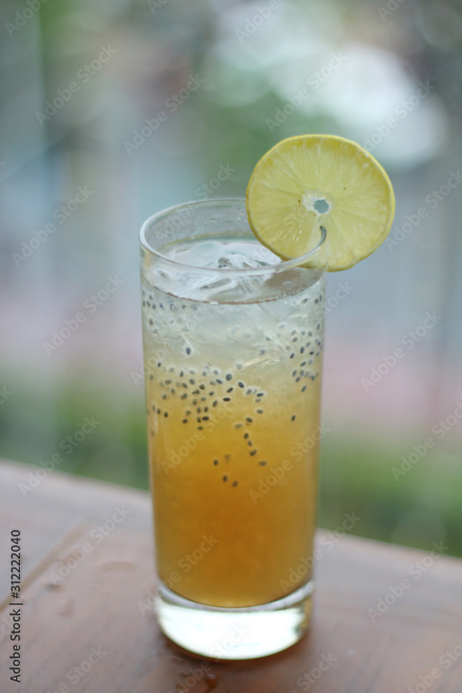 Fresh Juice Orange with basil seeds in blurred background. Ice Orange Fresh Juice Orange with basil seeds in blurred background. Ice Orange