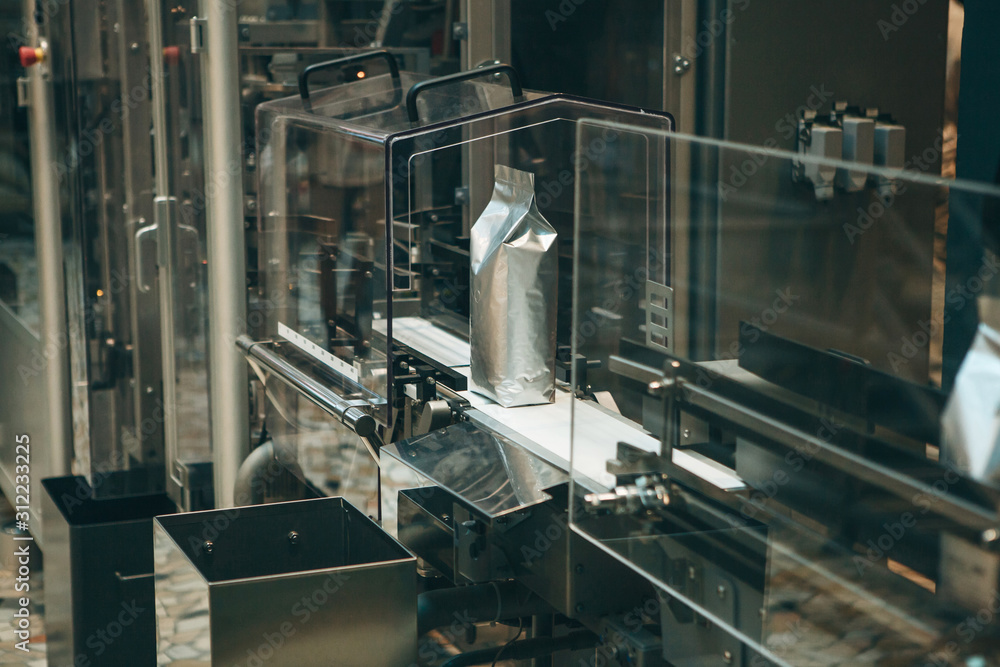 Conveyor for packing coffee beans in bags at a coffee factory for their further retail sale. Technological process Conveyor for packing coffee beans in bags at a coffee factory for their further retail sale. Technological process