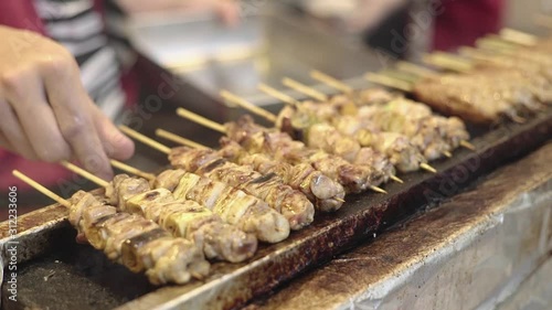 Grilling Yakitori or Grilled Skewers, Japanese Stall Street Food   photo