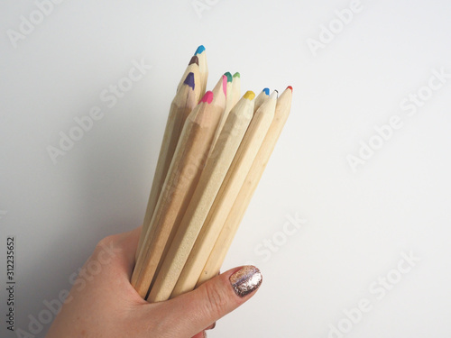 colored pencils in hand