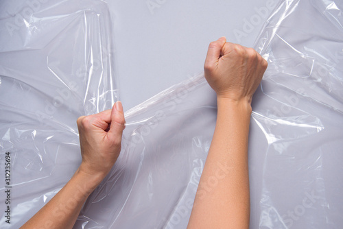 Woman hands pull polyethylene film