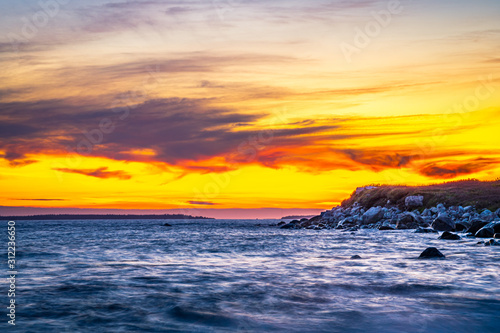 Long exposure seascape along Nova Scotia s rocky seacoast shoreline.