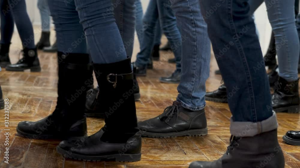 large group of children synchronously dance in blue jeans and black boots. training large group of children synchronously dance in blue jeans and black boots. training