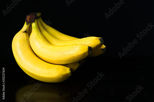 A bunch of bananas isolated on a black background. Copy space.