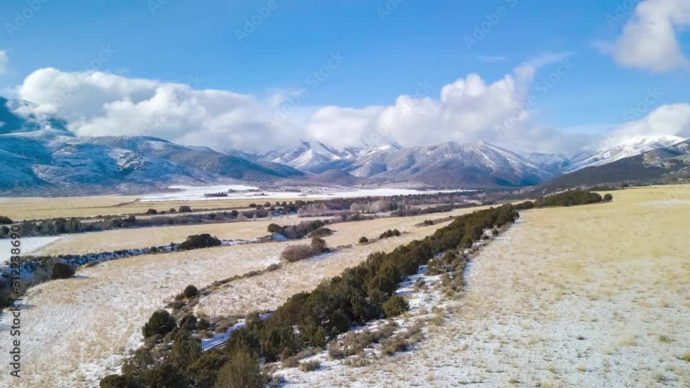 Drone motion hyperlapse along a dirt road in the country towards the distant mountains Drone motion hyperlapse along a dirt road in the country towards the distant mountains