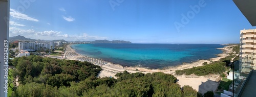 panoramic aerial view of Calla Millor beach calm blue sea and clear blue sky
