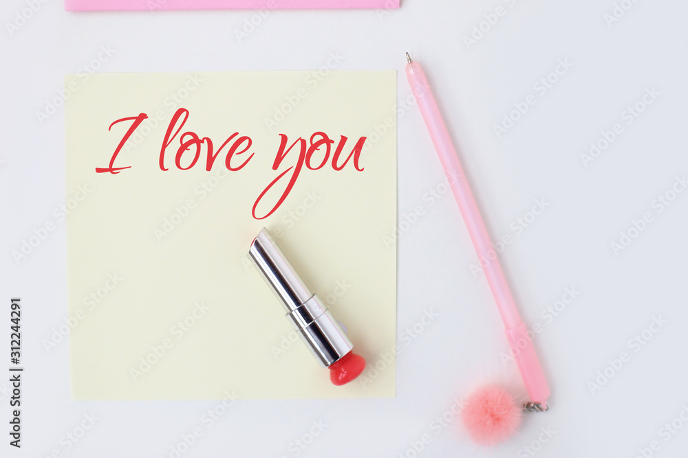 Flat lay: yellow paper, pink pen, pompom, lipstick, confetti hearts, lip print, i love you text. Making postcard in envelope for Valentine's Day. Do it yourself. Photo from the series Flat lay: yellow paper, pink pen, pompom, lipstick, confetti hearts, lip print, i love you text. Making postcard in envelope for Valentine's Day. Do it yourself. Photo from the series