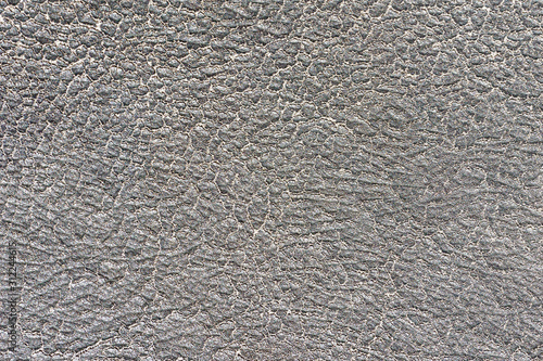 Gray, grunge cracked leather fabric texture.