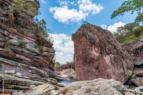 Natural pool hidden behing big rocks in brazilian national park 