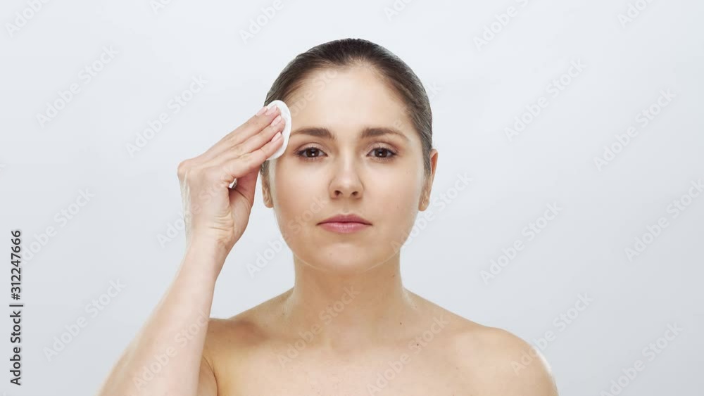 Studio portrait of young, beautiful and natural blond woman applying skin care cream. Face lifting, cosmetics and make-up. Studio portrait of young, beautiful and natural blond woman applying skin care cream. Face lifting, cosmetics and make-up.