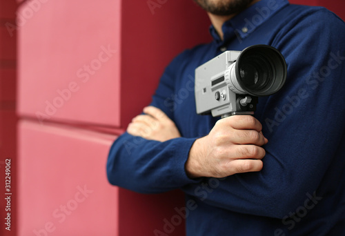 Man with vintage video camera outdoors, closeup