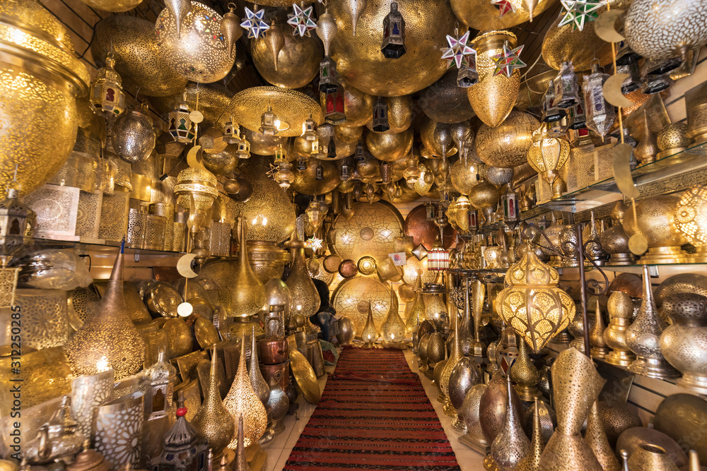 Fototapeta premium Moroccan style hanging lamps at the market in medina. Lamps and souvenir shops, Marrakech. Traditional moroccan market, Morocco in Africa. Store in Marrakech or Fes taken in December 2019 Nice gift