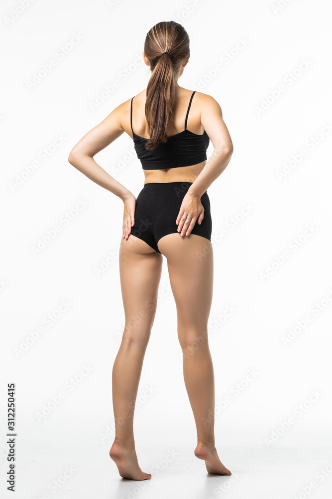 Rear view. Full height of fitness woman with a beautiful body in black lingerie isolated on white background Rear view. Full height of fitness woman with a beautiful body in black lingerie isolated on white background