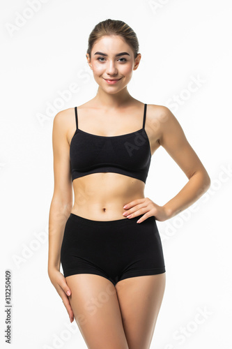 Fitness woman with a beautiful body in black lingerie isolated on white background