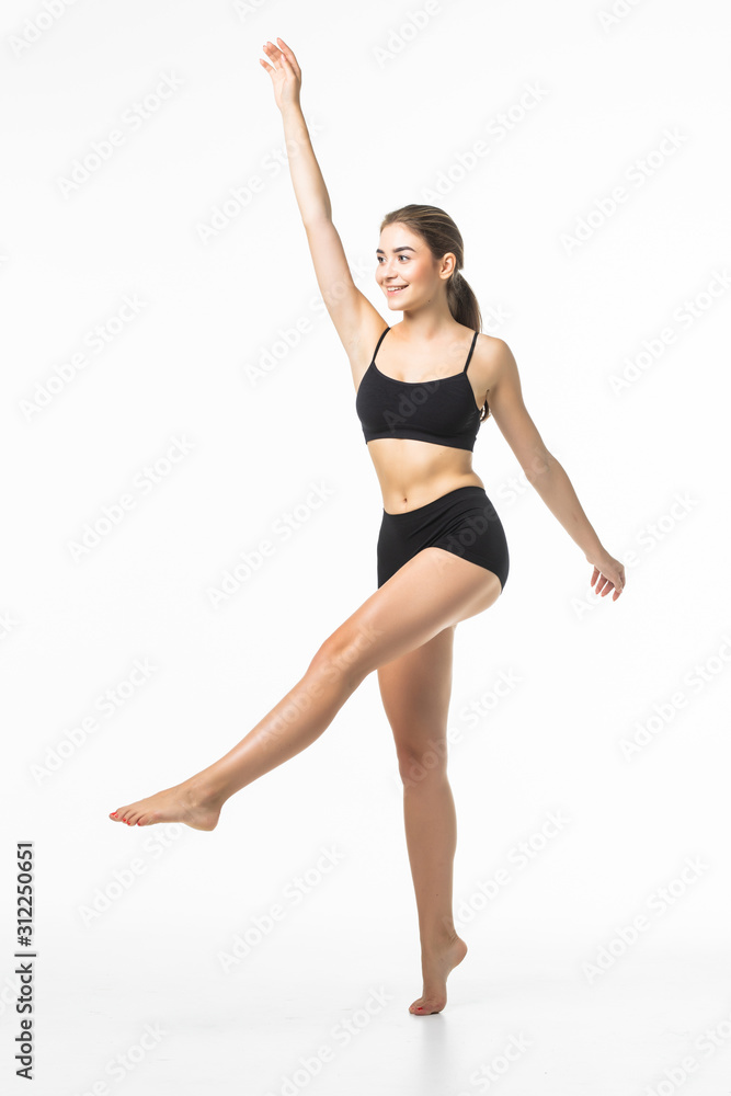 Full length portrait of a young brunette woman with perfect body raised hands in black sport lingerie posing and looking away isolated on a white background