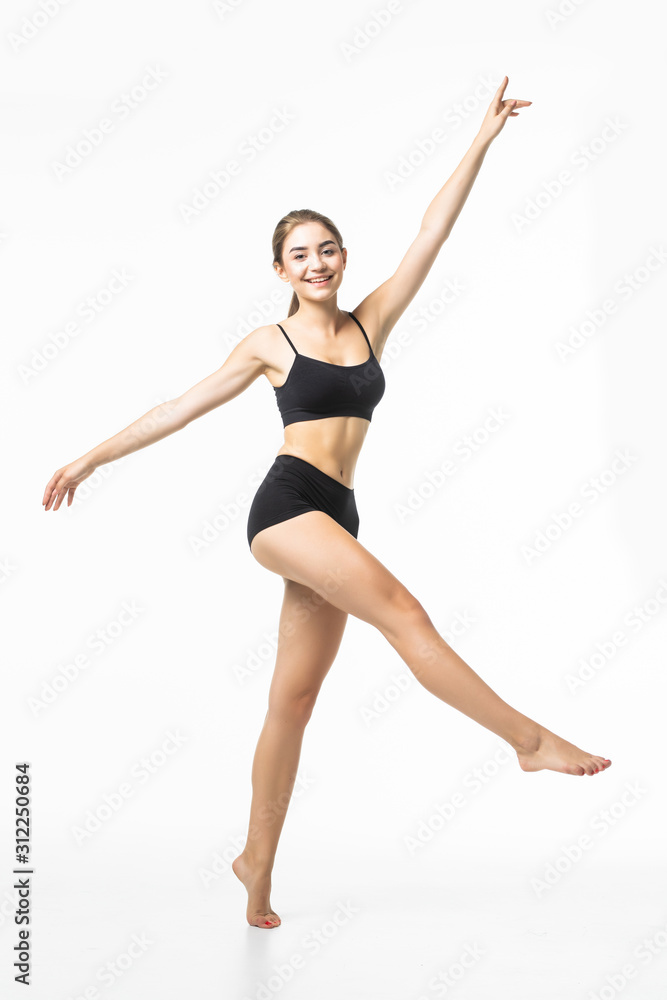 Full length portrait of a young brunette woman with perfect body raised hands in black sport lingerie posing and looking away isolated on a white background