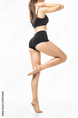 Rear view of young pretty woman with perfect body wear in black underwear isolated on white background