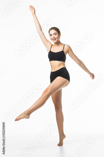 Full length portrait of a young brunette woman with perfect body raised hands in black sport lingerie posing and looking away isolated on a white background © F8  \ Suport Ukraine