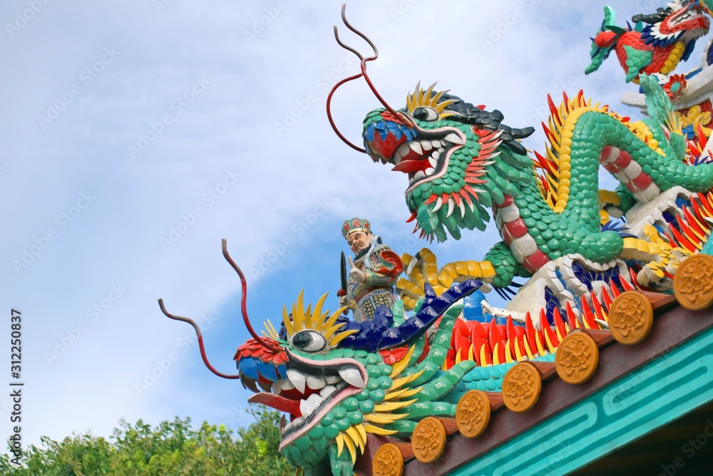 Dragons, ornaments and other religious symbols on a Chinese shrine in Phuket, Thailand. Dragons, ornaments and other religious symbols on a Chinese shrine in Phuket, Thailand.