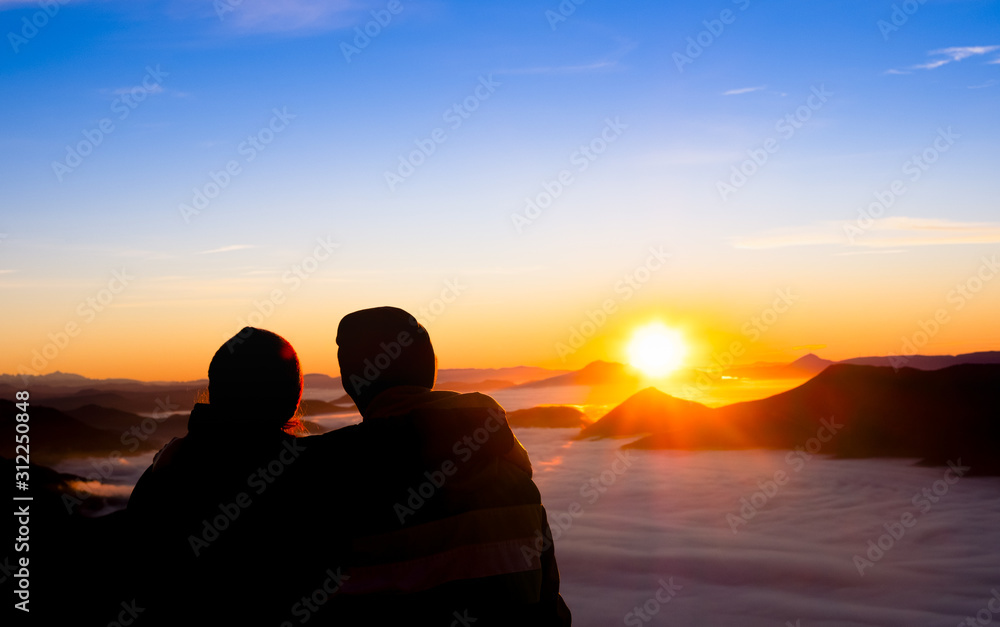 Young couple at sunrise in the Sierra de Aralar with the mountains of Navarra in the background
