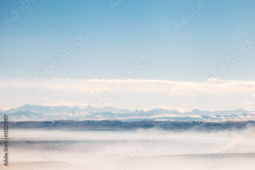 aerial view on a mountains covered clouds from the plane © slayer87