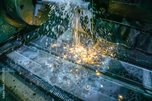 Fototapeta Naklejka Na Ścianę i Meble -  Grinding machine for metal processing with abrasive tools in production with cooling and sparks.