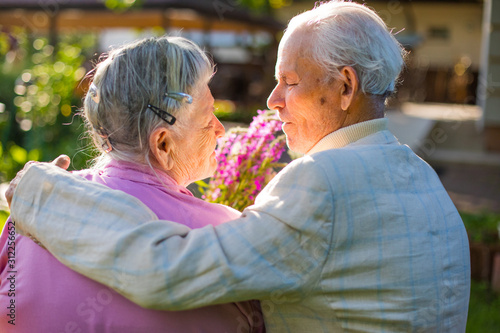 Romantic grandparents 90 years old. Two caucasian senior citizens are embracing each other. Elderly couple marriage  in love
