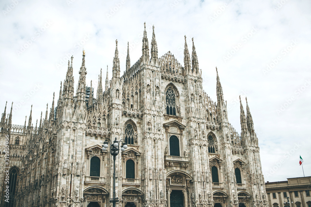 Beautiful view of the ancient Duomo Cathedral in Milan in Italy. It is one of the most popular tourist attractions in Italy.