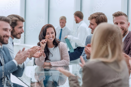 confident business woman explaining something to her business partners
