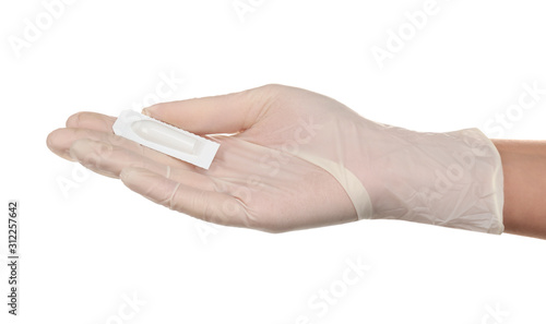 Doctor holding suppository on white background. Hemorrhoid problems