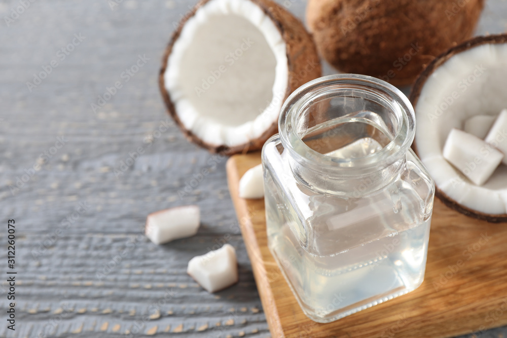 Coconut oil on grey wooden table, closeup, space for text Coconut oil on grey wooden table, closeup, space for text