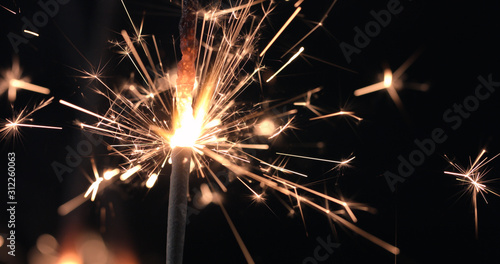 Firework sparkler burning on black background. Merry Christmas and happy new year celebration