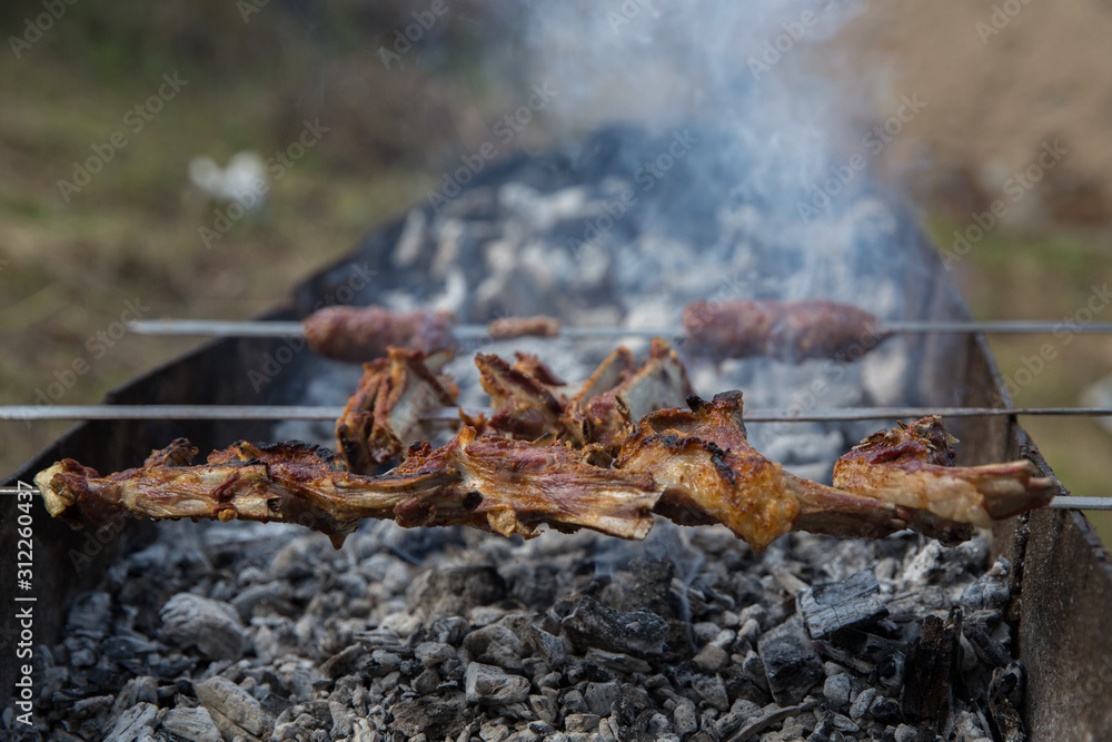 Lula kebab on skewers , traditional Caucasian dish, close-up . Appetizing lula kebab grilled on metal skewer. Shish kebab on a metal stick, top view.