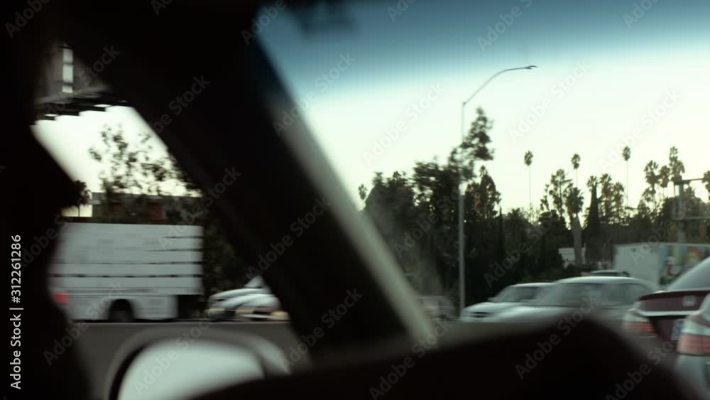 Man driving a car on a sunny day in California Man driving a car on a sunny day in California