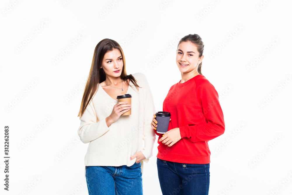 Two smiling students with takeaway coffee standing isolated on white background Two smiling students with takeaway coffee standing isolated on white background
