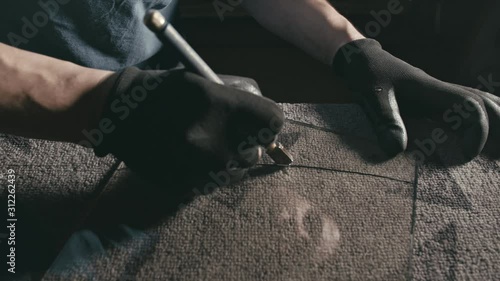 Forge. Smithy. Glass cutting and processing for fireplace doors. Circular glass cutter. Worker cut glass with glass cutting diamond. Polish an angle grinder with an abrasive circular disk nozzle.